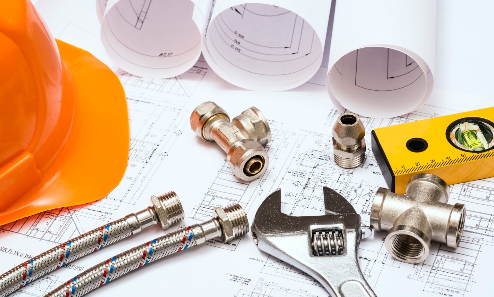 Standard construction safety equipment on architectural drawing of house, building or home project.